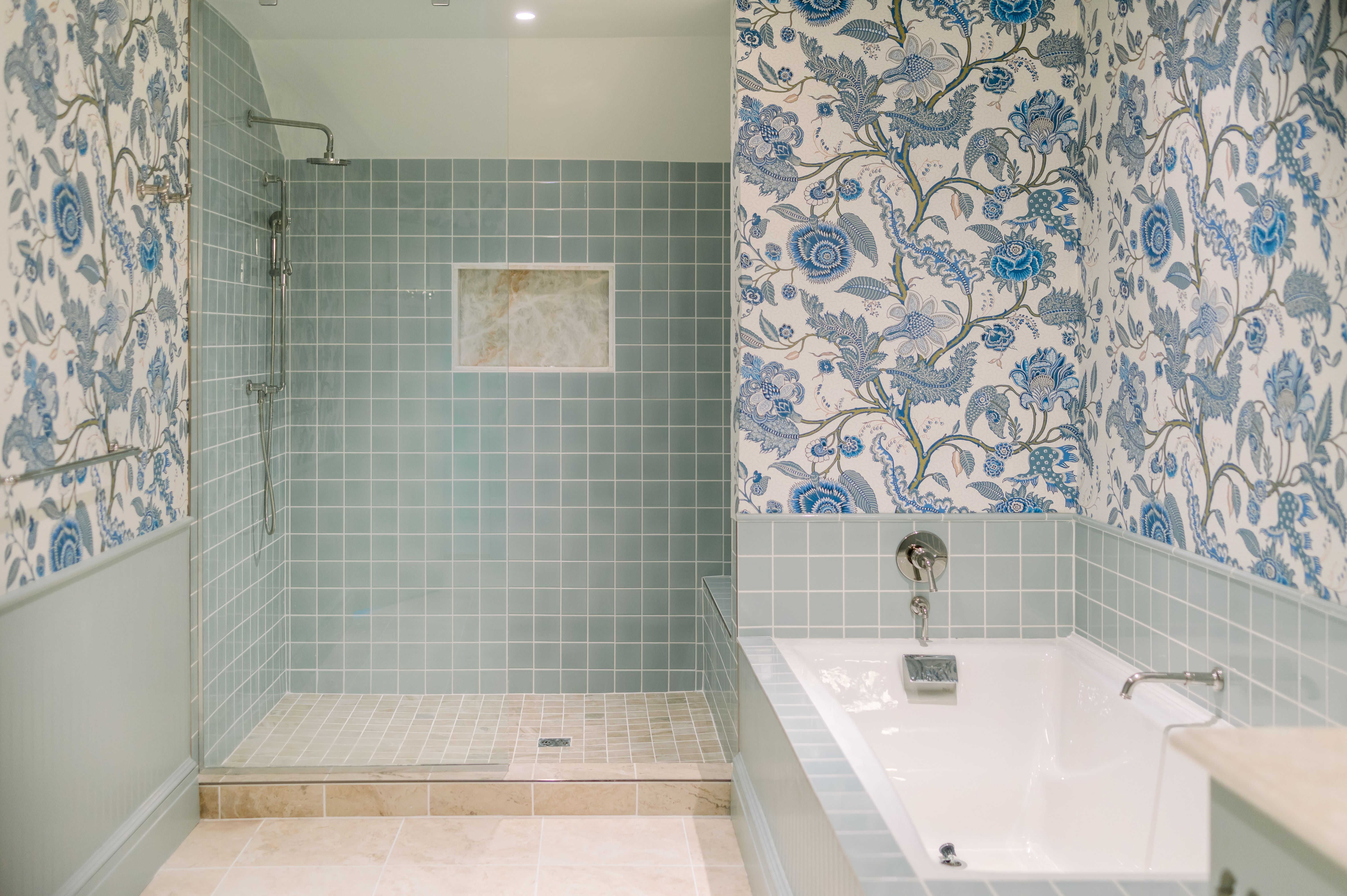 image Retreat to a tranquil bath where calming tilework and floral accents create a spa-like sanctuary.