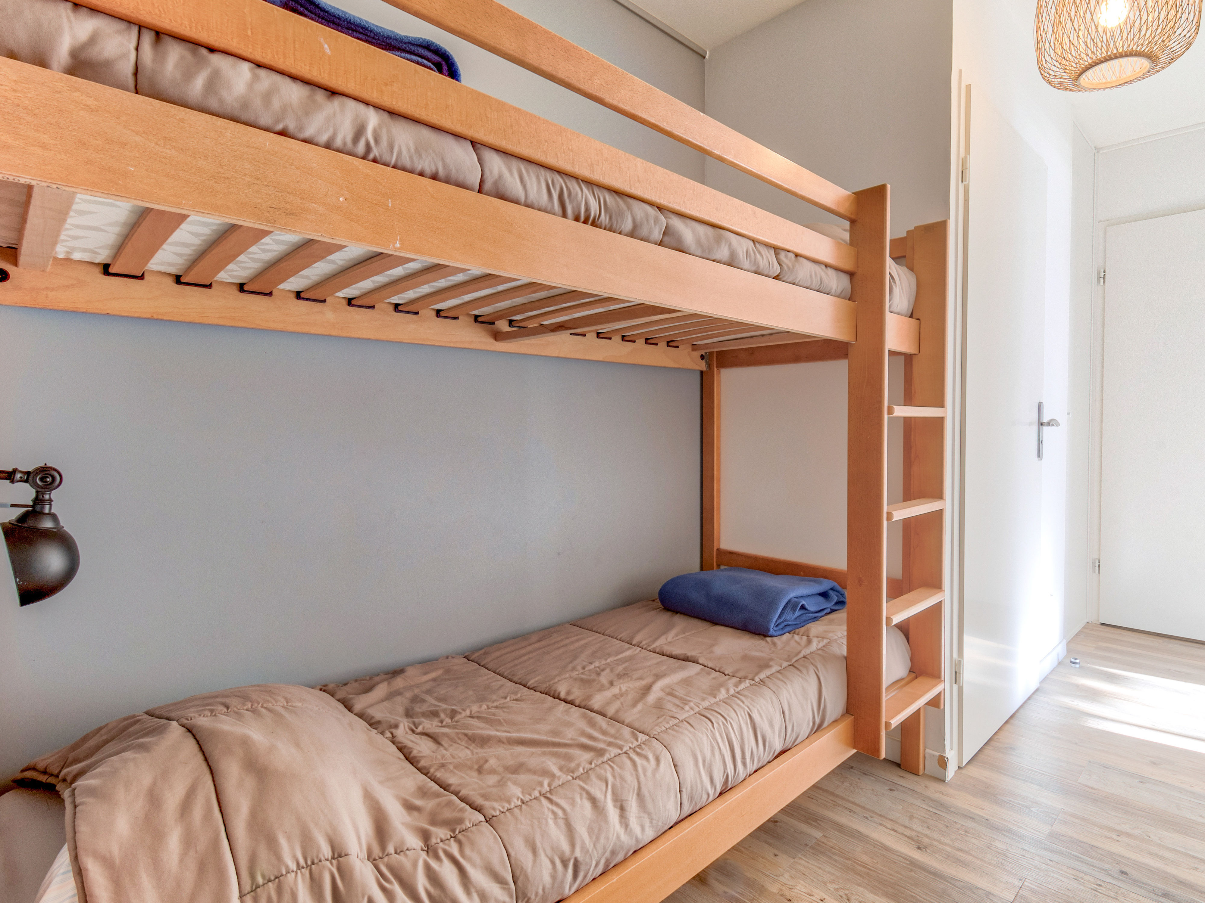 image Cheerful bunk bedroom with natural light, ideal for sharing stories at the end of the day.