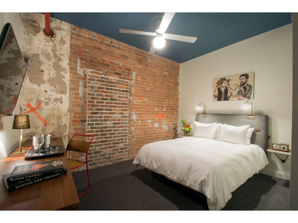 image Bedroom blending exposed brick and modern lighting for an urban oasis