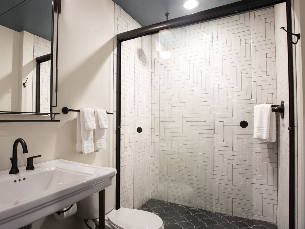 image Contemporary bathroom featuring dual sinks and chic subway tile design