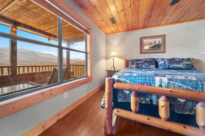 Wake up to the beauty of the Smokies in this airy bedroom, offering a stunning view from the balcony!