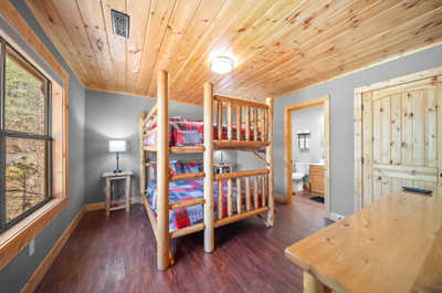 Perfect for kids or extra guests, this bunk room boasts cozy beds and a quaint work area for journaling or planning tomorrow's adventures.