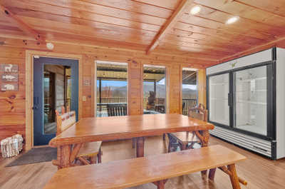 Rustic charm meets family dinners at this ample wooden dining table set against the backdrop of rich, natural wood interiors.