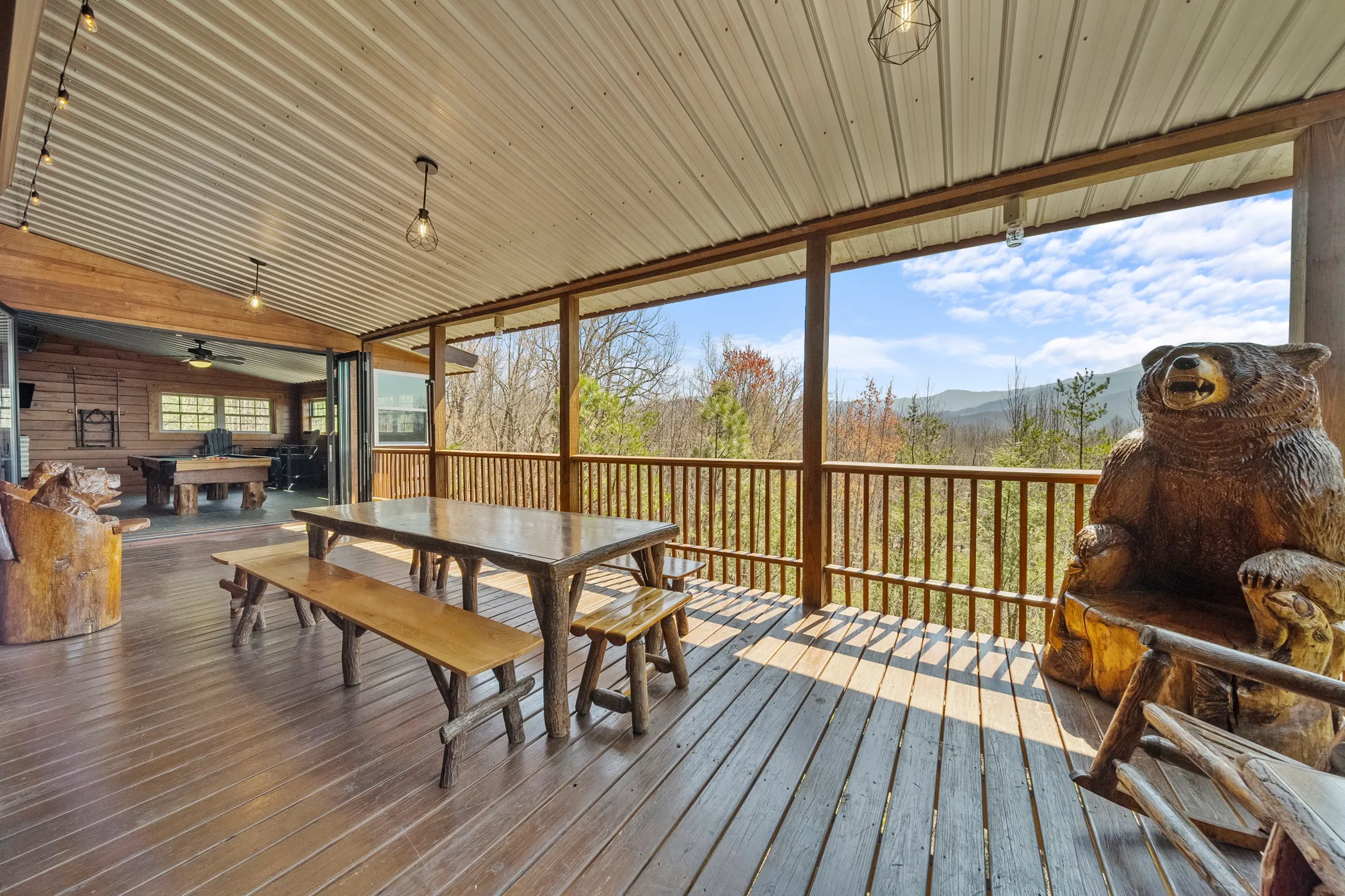 image Rustic charm meets the great outdoors; relax on the deck alongside our friendly wooden bear carving, overseeing the sweeping mountain views.