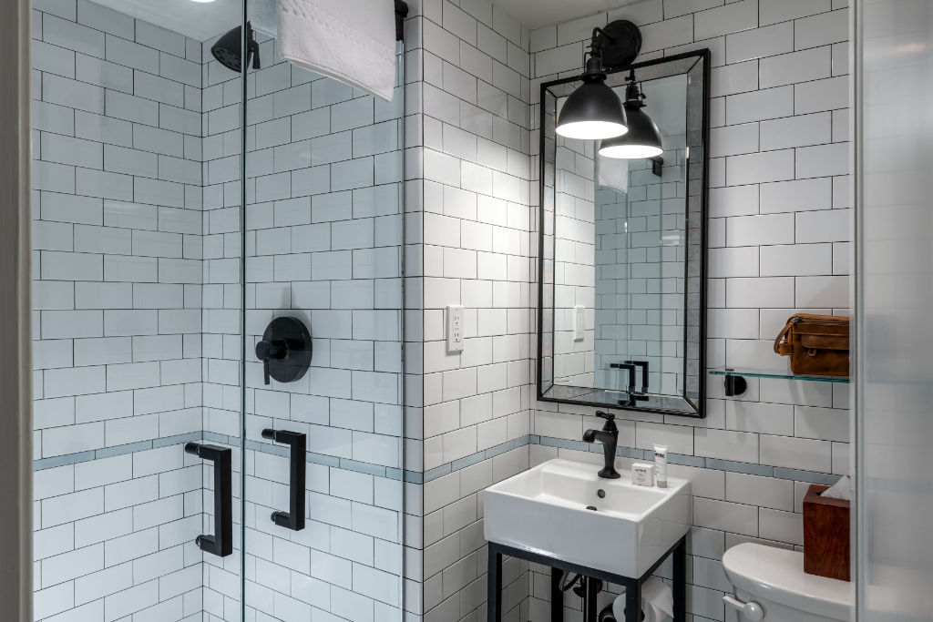 image Modern bathroom with a classic touch, featuring subway tiles and sleek fixtures for a luxurious feel.