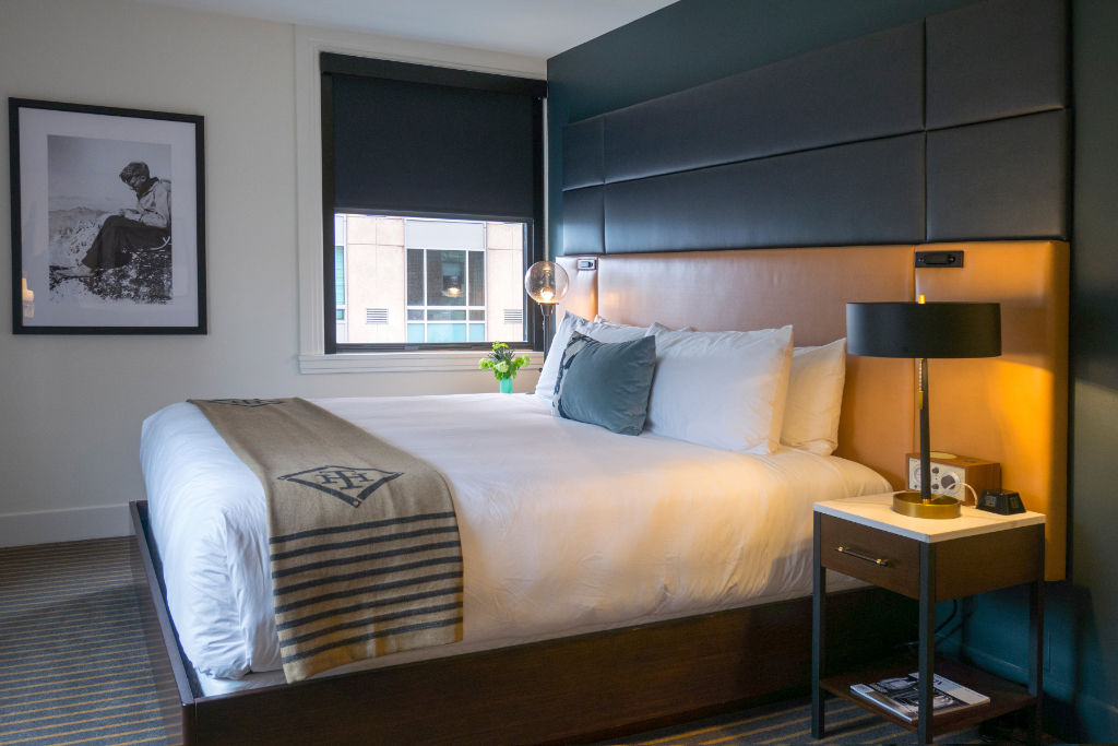 image Soft lighting and a plush bed create a haven of tranquility with a touch of modern flair.