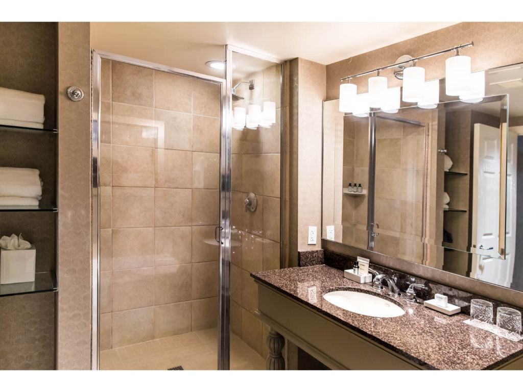 image Modern bathroom with clean lines and reflective surfaces, providing a refreshing space to rejuvenate.