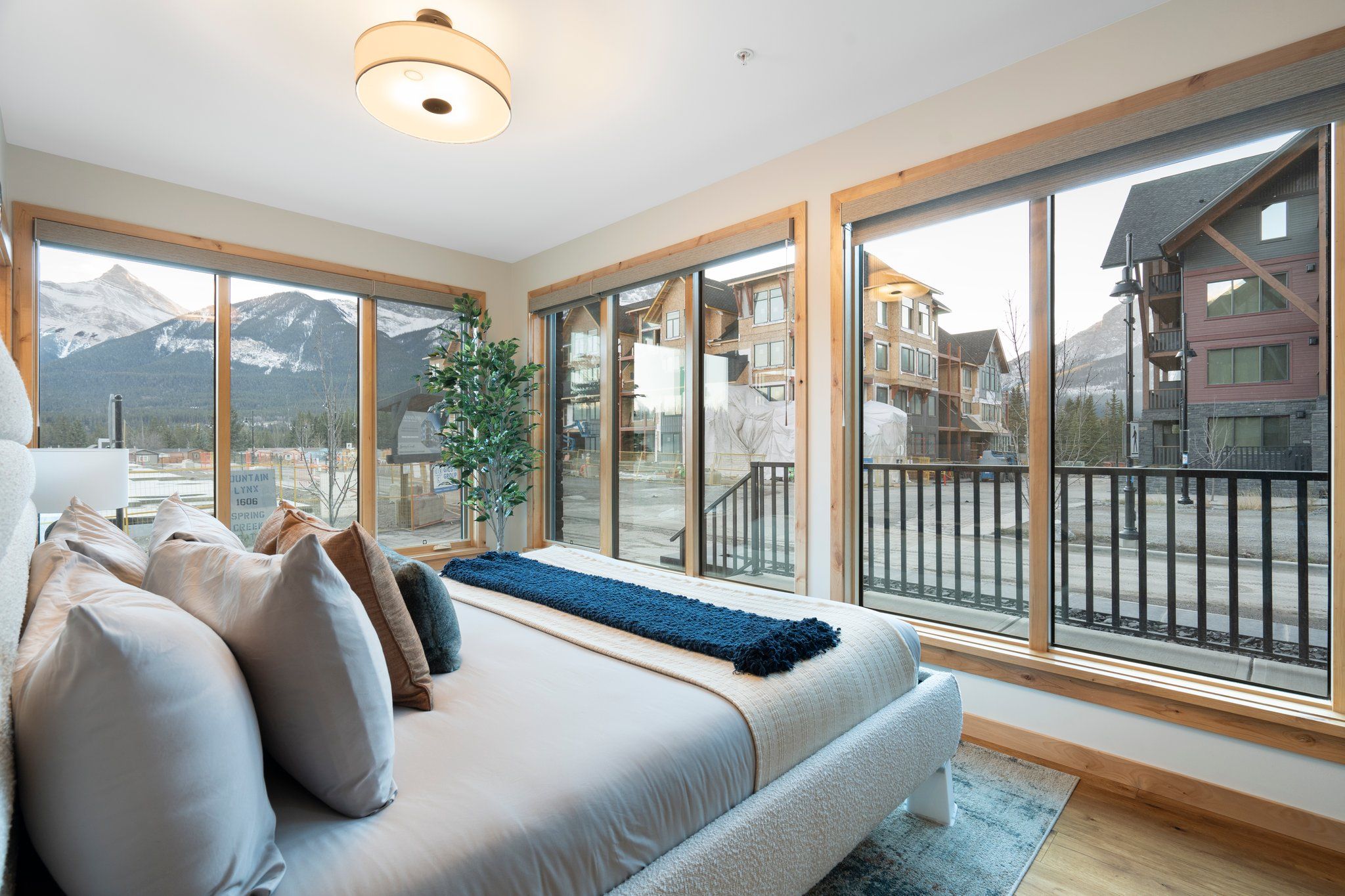 image Wake up to breathtaking mountain views from the king bed in Master Bedroom 1, offering deck access for an immersive nature experience.