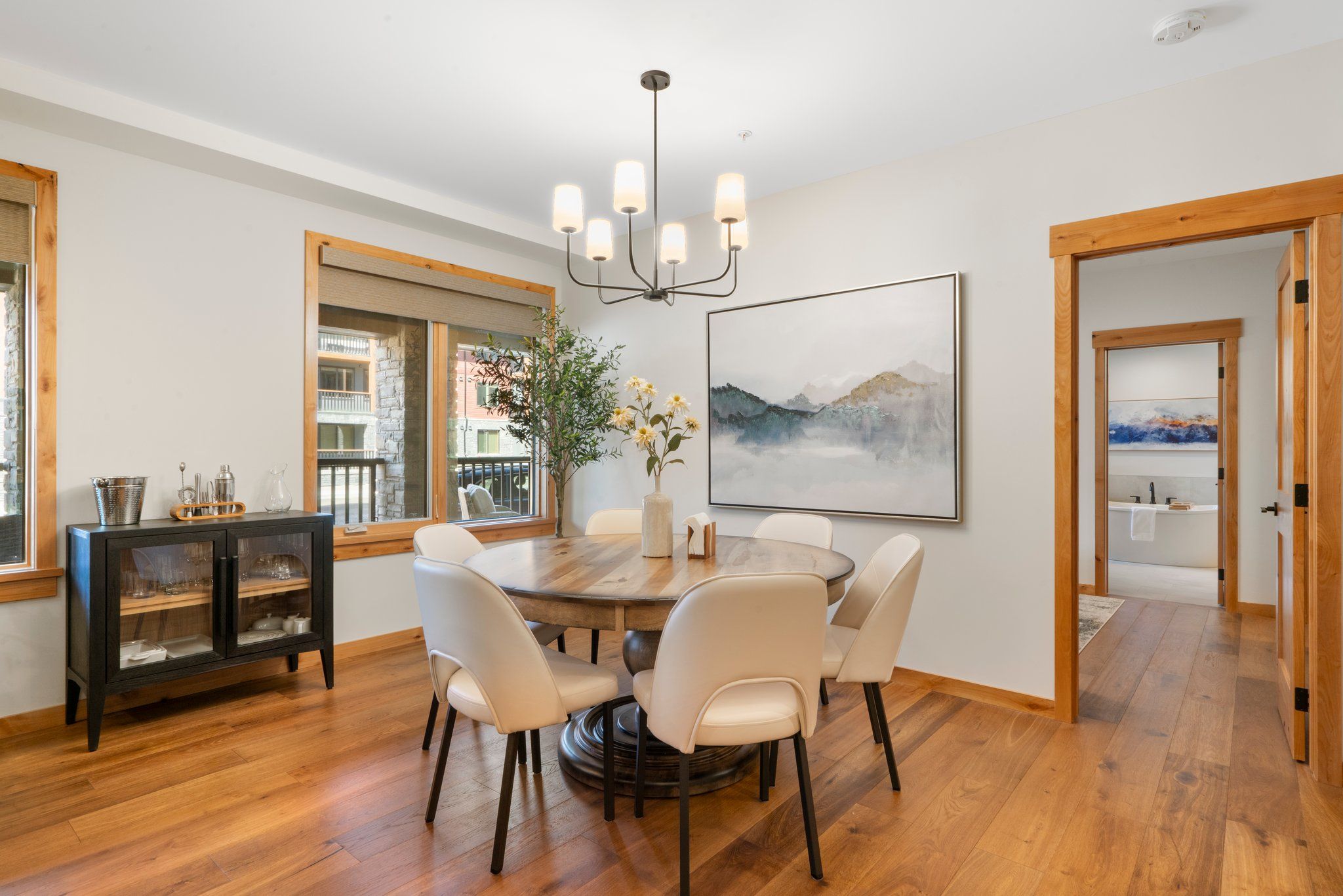 image Gather around the elegant dining table for a memorable meal with stunning views, a space designed for conversation and culinary delights.