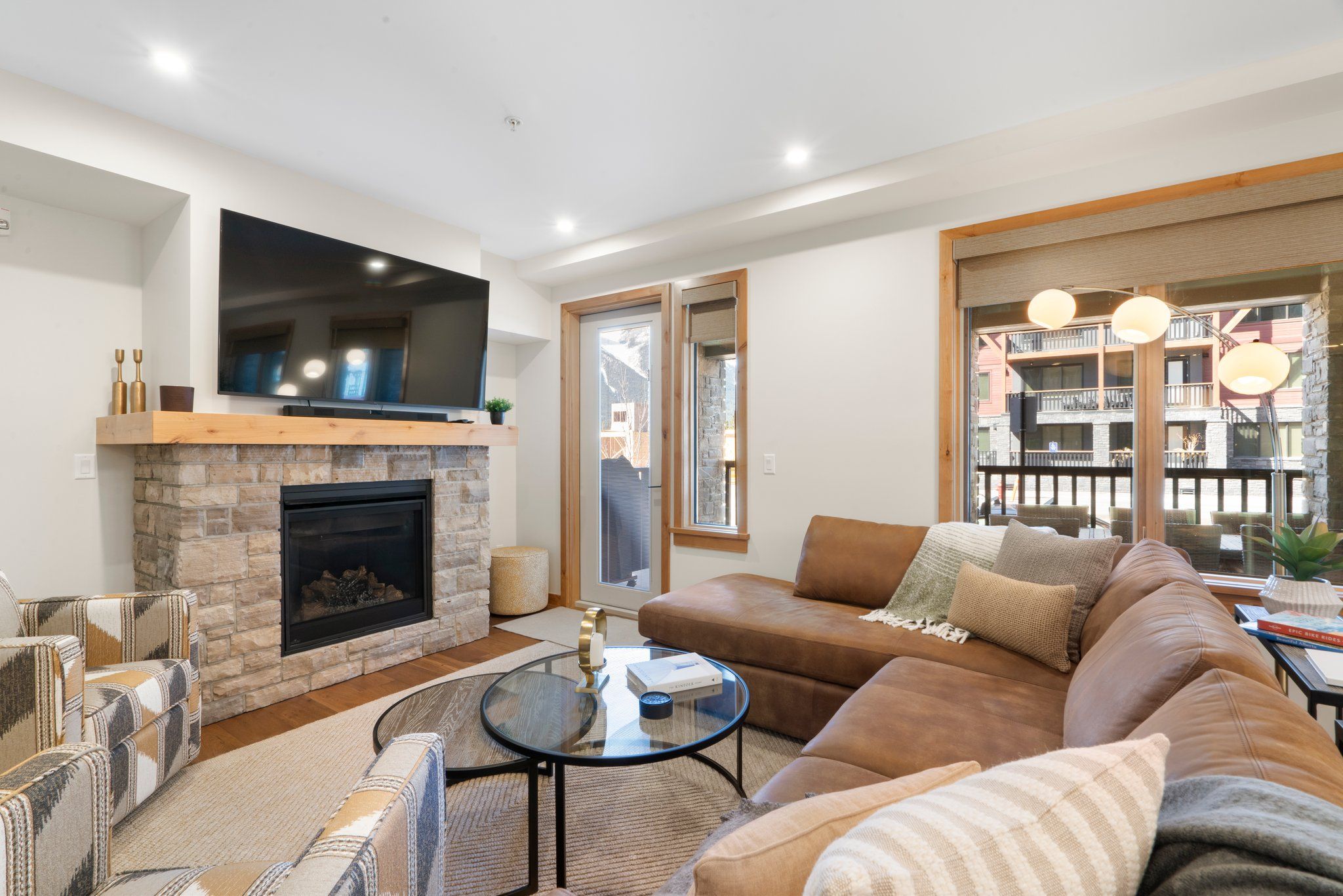 image Relax in the plush living room, featuring a cozy gas fireplace and chic decor, providing the perfect backdrop for mountain relaxation.
