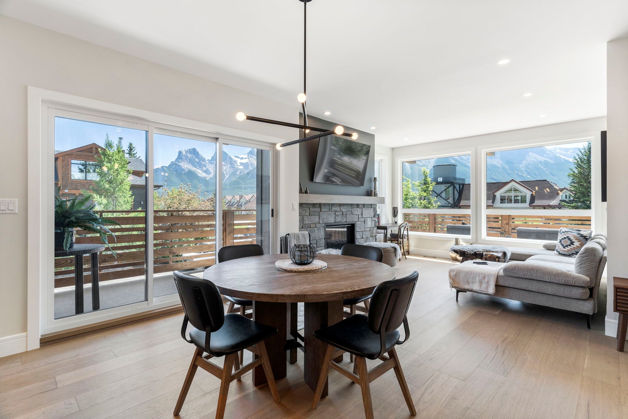 image Enjoy family meals in the bright and airy dining area, featuring large windows with stunning mountain views.