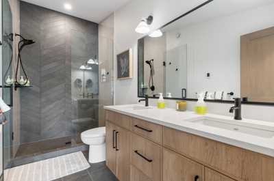 Ensuite bathroom with dual vanities, spacious walk-in shower, and elegant fixtures for a spa-like experience