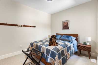 Cozy bedroom located on the main level with a plush bed and delightful decor.