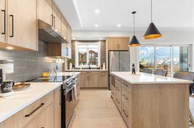 Sleek and stylish kitchen featuring a large island, perfect for meal prep and casual dining.