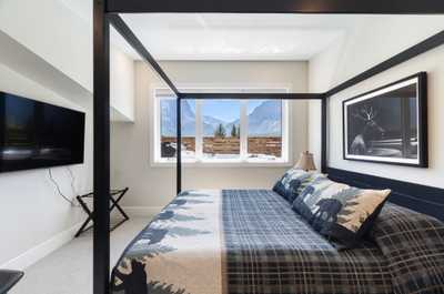 Retreat to the cozy master bedroom with a comfortable king bed and beautiful mountain scenery right outside your window.