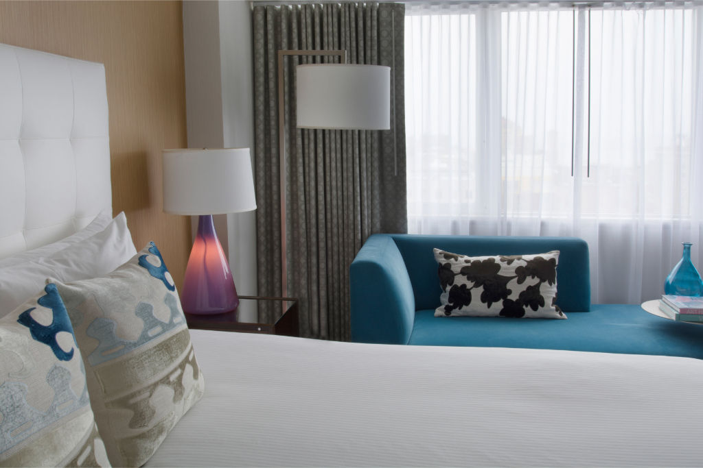 image Luxurious bedroom showcasing plush bedding with bold accents, creating a serene and inviting atmosphere.