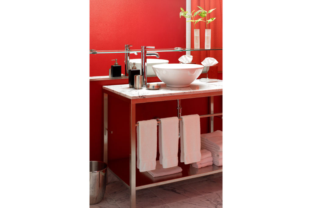 image Refreshingly modern bathroom with bright red walls and contemporary amenities, offering a vibrant start to your day.