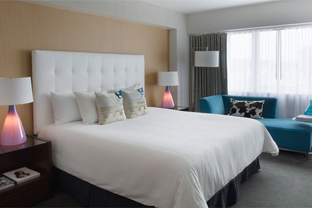 image Spacious and bright room featuring a comfortable king bed and refreshing accents, perfect for a rejuvenating stay.