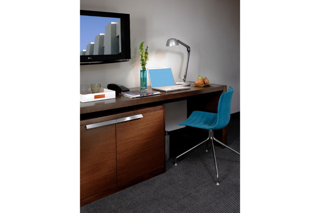 image Practical workspace equipped with a sleek desk and vibrant chair, ideal for staying productive in a comfortable setting.