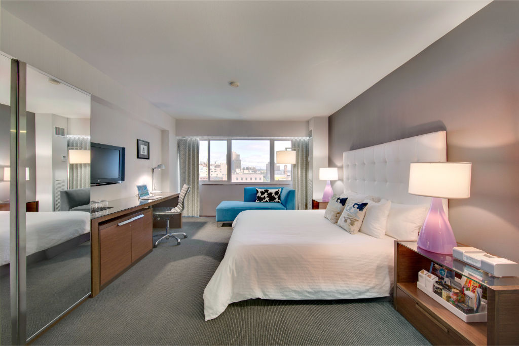 image Spacious and well-lit room featuring contemporary furnishings and soothing color tones, perfect for a comfortable stay.