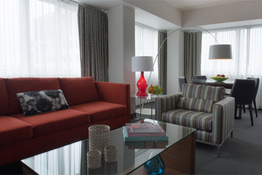 image Spacious living area with a plush sofa and modern decor, blending comfort and style.