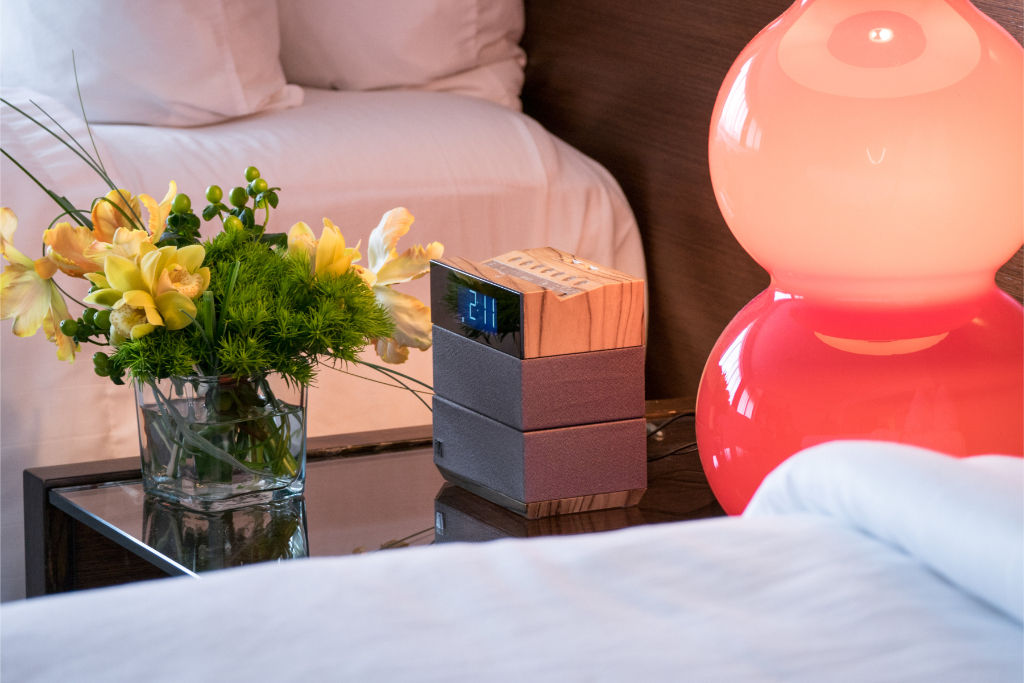 image Charming bedside scene with vibrant floral arrangements and playful lampshades, adding a personal and inviting touch to your stay.