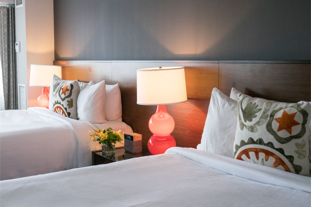 image Inviting bedroom with plush bedding and tasteful decor, perfectly arranged for a peaceful night's sleep.