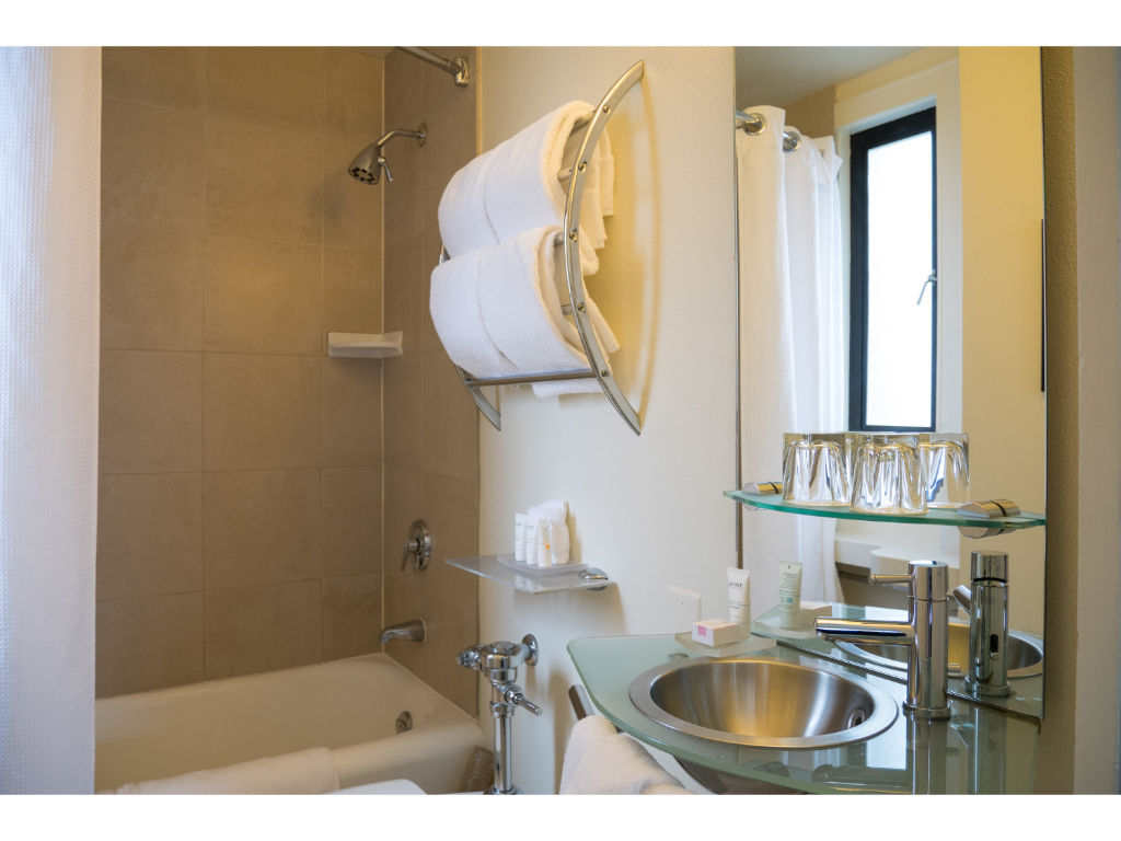 image Elegant bathroom with classic fixtures and a large mirror, providing a bright space for rejuvenation.