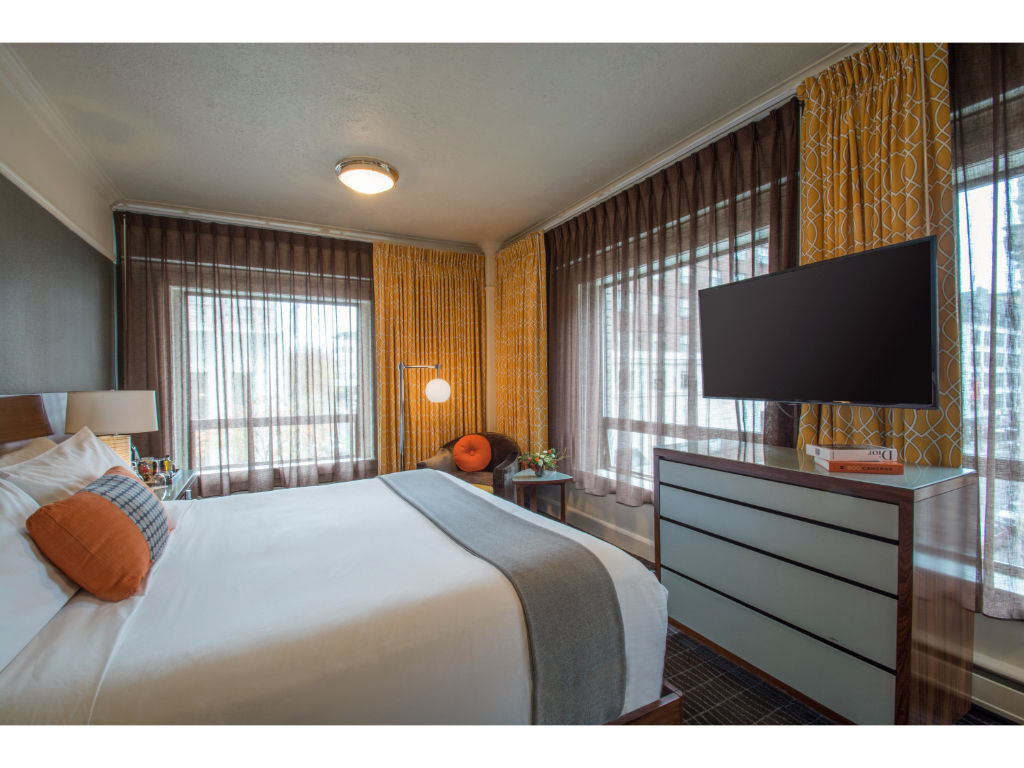 image Relax in comfort: Cozy king bed with luxurious linens and ambient lighting in our superior room.