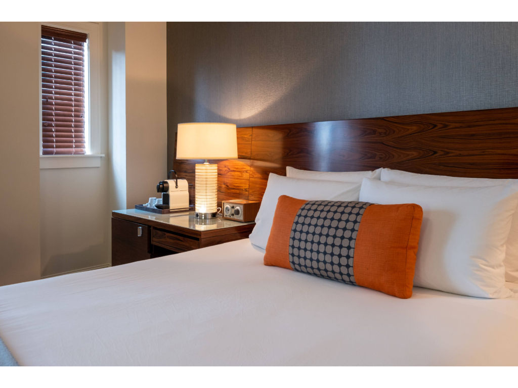 image Spacious and inviting Queen room with contemporary furnishings and a refreshing color palette.