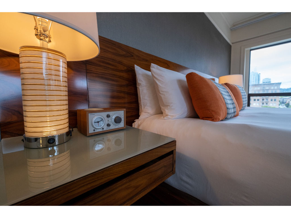 image Queen room detail highlighting the chic bedside setting with stylish decor and natural light.