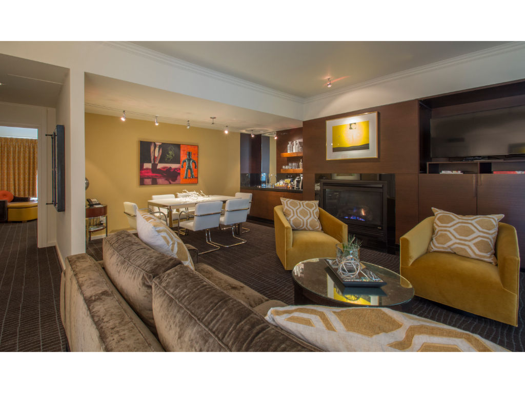 image Luxurious Gallery Suite living area, elegantly furnished with plush seating and vibrant accents for a touch of sophistication.