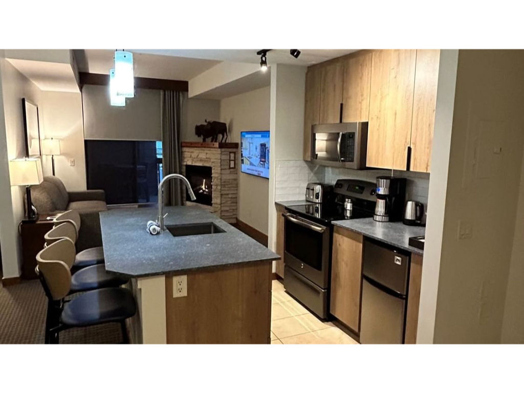image Sleek open kitchen with a spacious island and stylish lighting, perfect for cooking and entertaining.