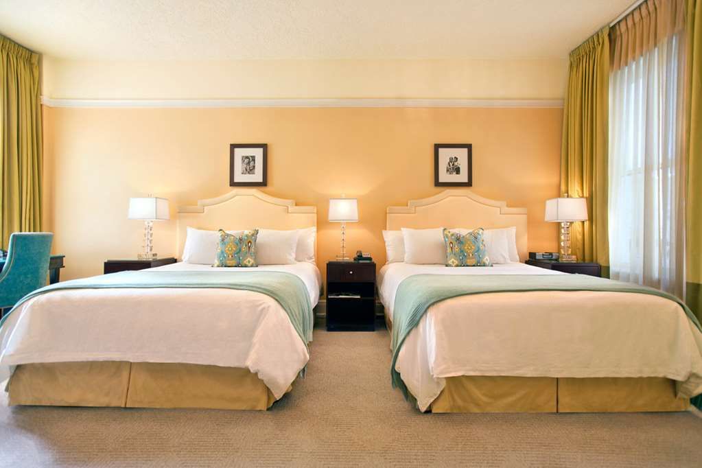 image Premium room with two queen beds, offering spacious comfort, elegant decor, and modern amenities for a relaxing stay.