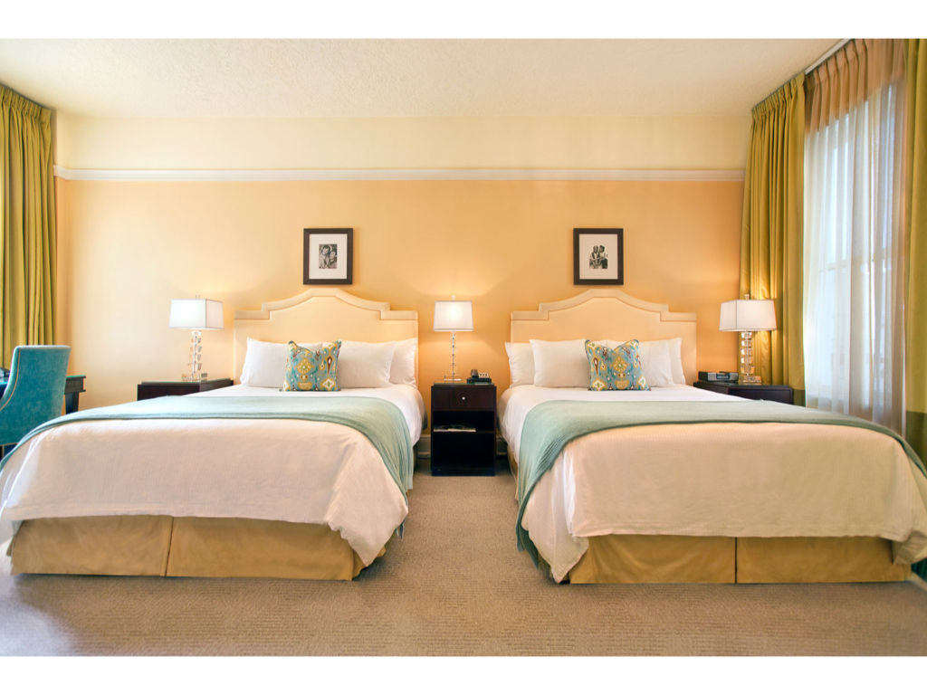 image Premium room with two queen beds, offering spacious comfort, elegant decor, and modern amenities for a relaxing stay.
