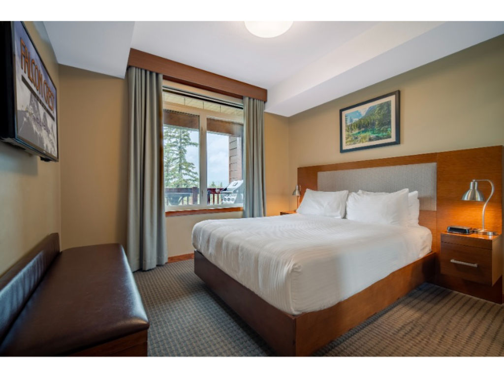 image Tranquil bedroom with soft lighting and a private balcony, creating a cozy and restful retreat.