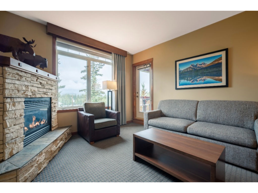image Cozy living area with a stone fireplace and plush seating, perfect for unwinding after a long day.