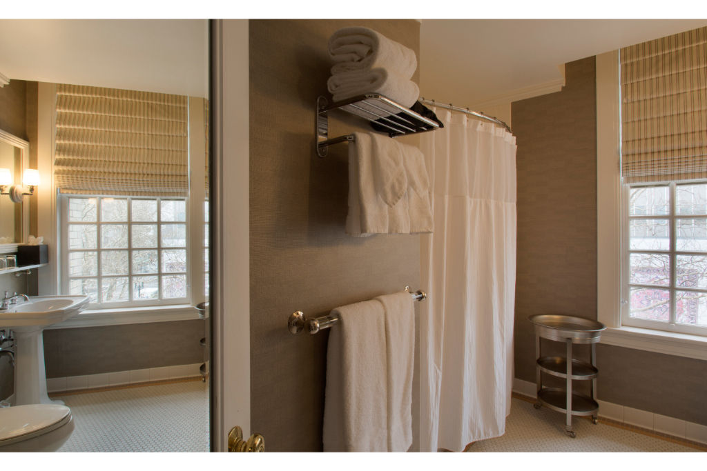 image Indulge in a roomy shower within this well-designed bathroom, complete with modern amenities and bright lighting.