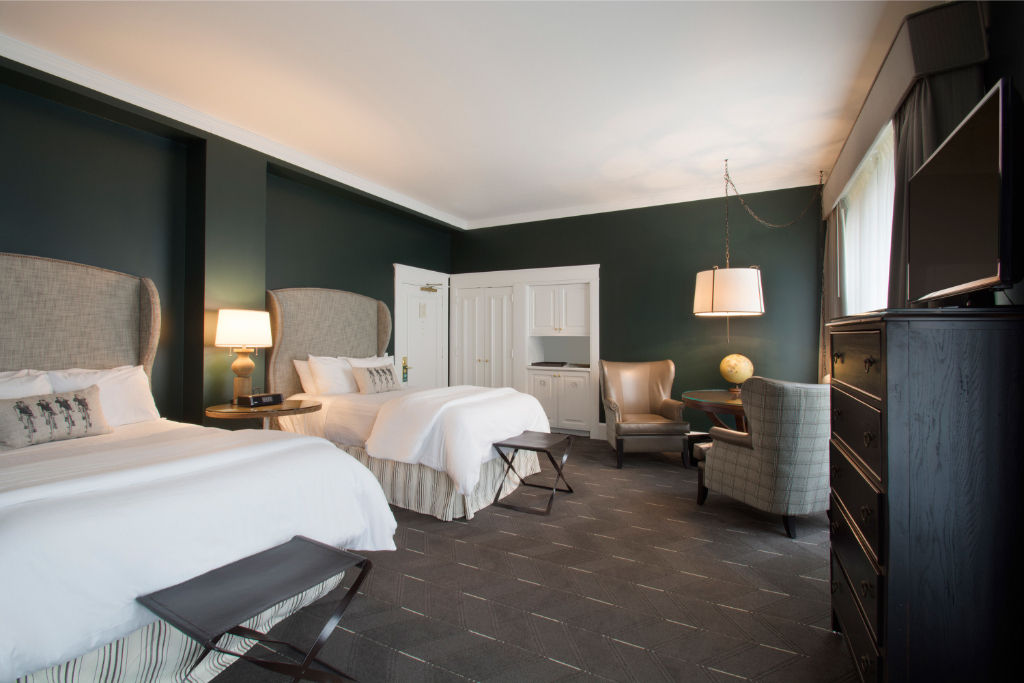 image Rest comfortably in this elegant bedroom featuring plush beds, modern decor, and a tranquil ambiance.