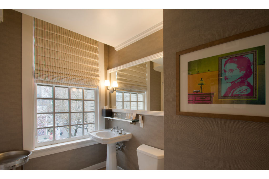 image Refresh in the stylish bathroom, featuring modern fixtures, natural light, and chic artwork.