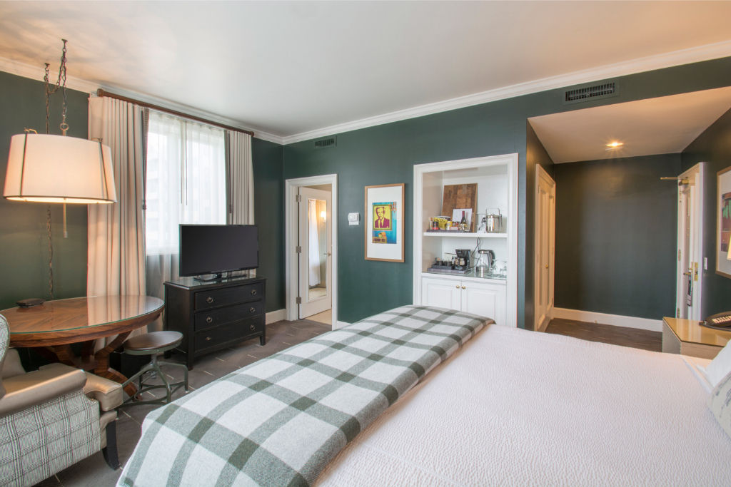 image Relax in the comfort of a stylish bedroom with a cozy king bed, modern furnishings, and large windows.