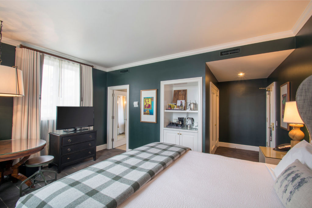 image Unwind in this luxurious bedroom featuring a plush king bed, elegant decor, and ample natural light.
