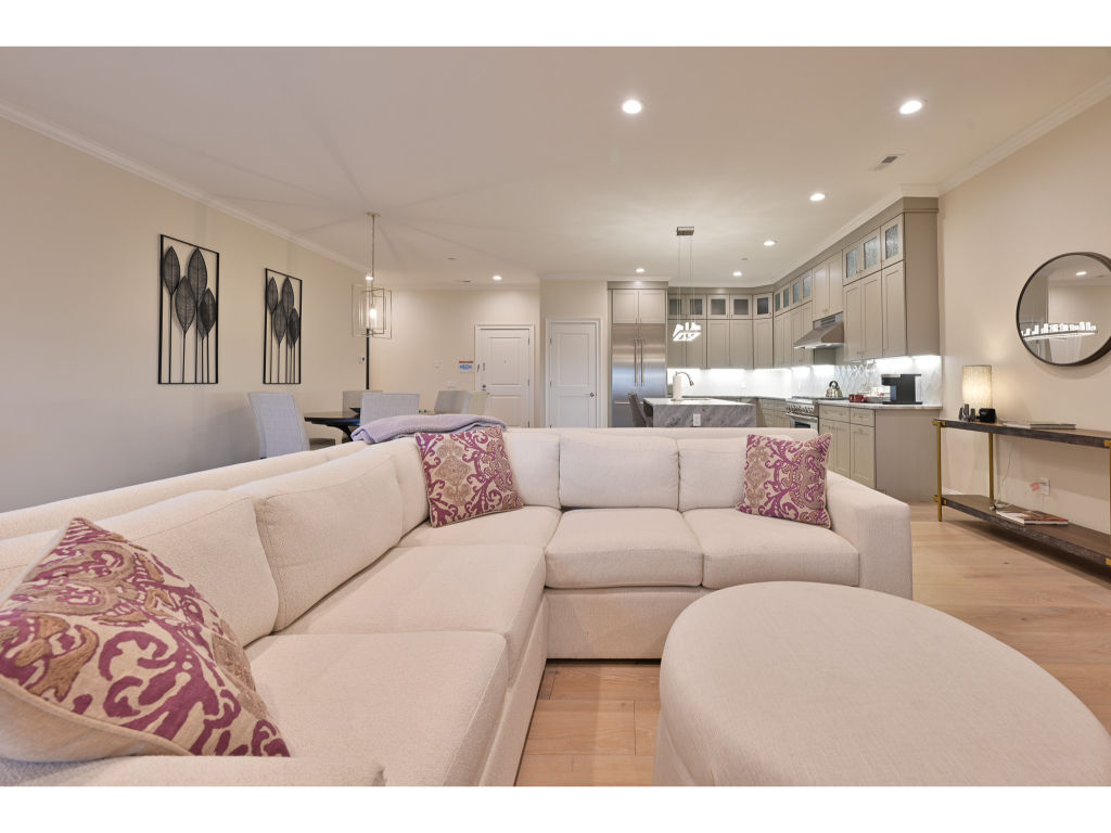 image Spacious and stylish living area with a large sectional sofa, perfect for relaxing and socializing with family and friends.
