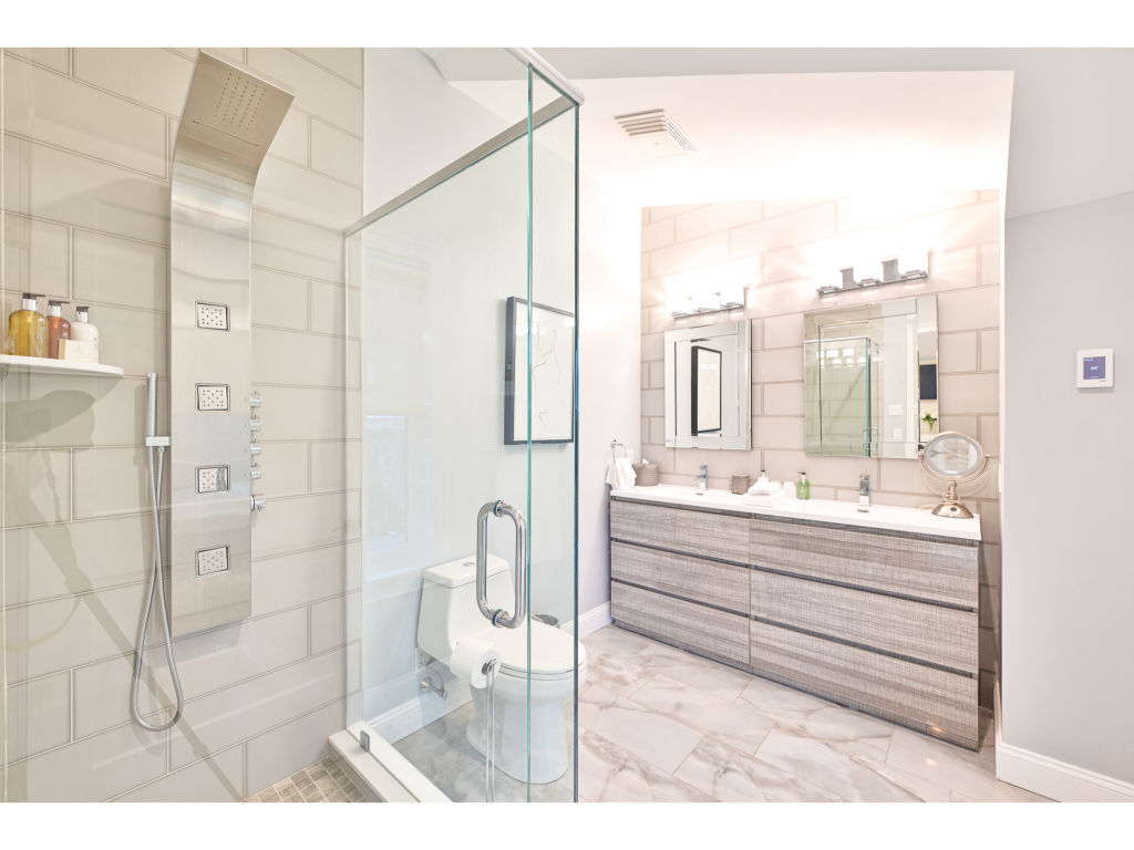 image Elegant bathroom with a glass-enclosed shower, double vanity, and modern fixtures for a luxurious experience.
