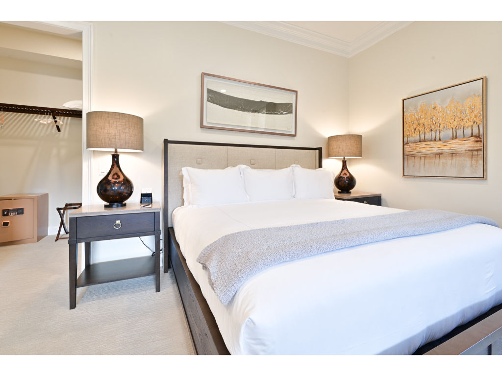 image Spacious bedroom with a comfortable king bed, contemporary decor, and a serene atmosphere for a restful night's sleep.
