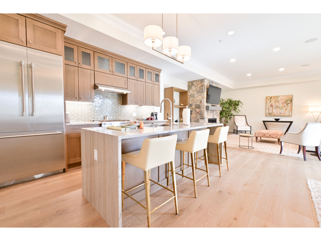 image Modern kitchen featuring a large island with bar seating, high-end appliances, and an open layout perfect for entertaining.