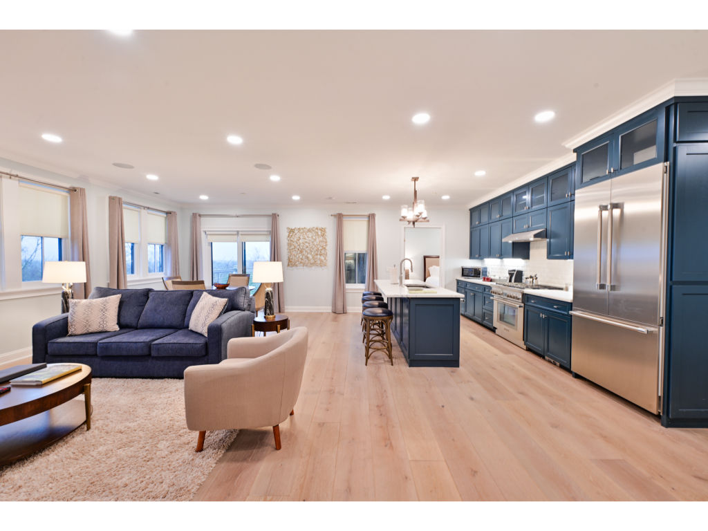 image Spacious open-concept living area with modern furnishings and a fully equipped kitchen. Perfect for entertaining!