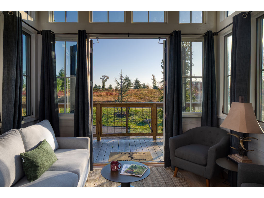 image Experience tranquility and comfort with stunning views right from the living area of this charming tiny home.