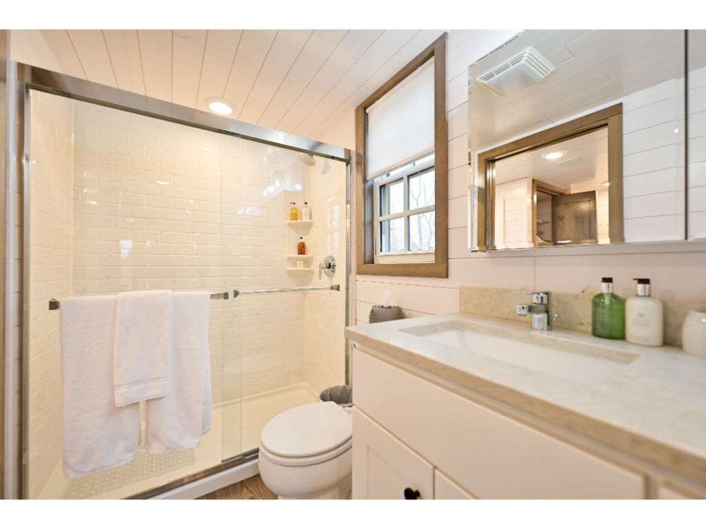 image Experience luxury in the stylish bathroom, featuring a sleek vanity, spacious shower, and contemporary finishes.