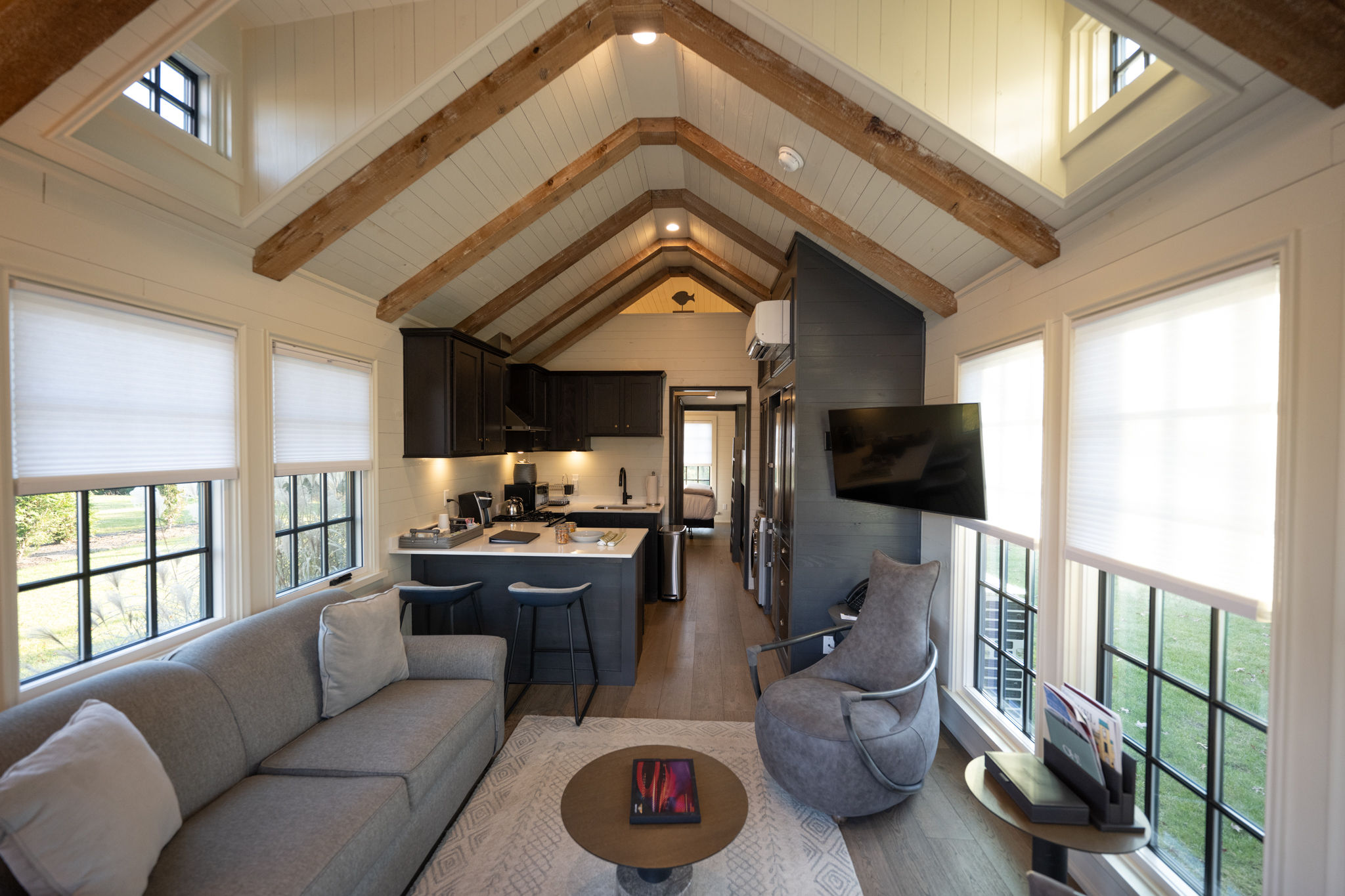 image An open-concept living area with high, vaulted ceilings, creating an airy, relaxing space perfect for gathering.